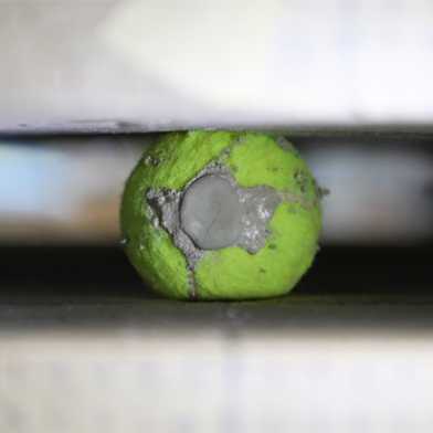 Used, cement-filled tennisball