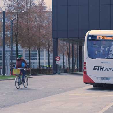 Electric bus and cyclist on ETH Campus Hönggerberg