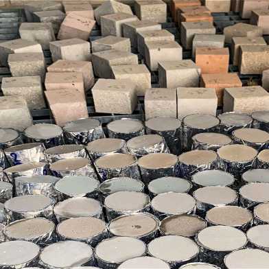 Concrete cubes and cylinders stacked next to each other