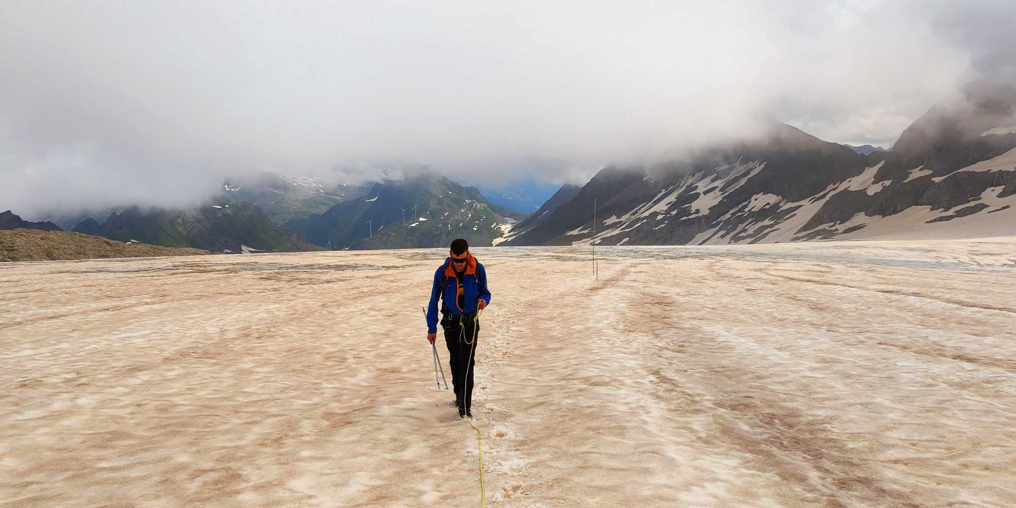 A man walking over a glacier