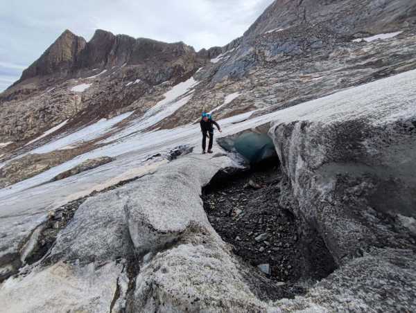 a person on a glacier crack