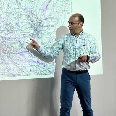 Prof. João P. Leitão shows something on a map