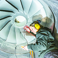 Woman fixes sensor to turbine