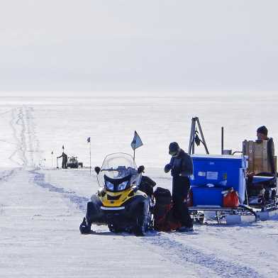 This image shows Antarctica and researchers setting up posts at regular intervals.