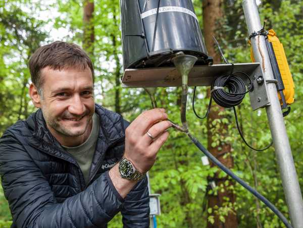 The researcher smiles and shows the installation.