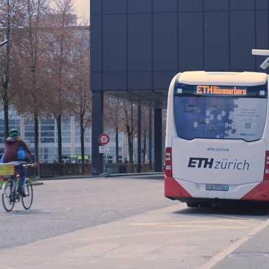 Electric bus and cyclist on ETH Campus Hönggerberg